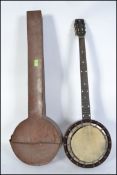 An early 20th century rosewood banjo ( musical instrument ) unstrung but complete with the original