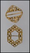 Two early 20th century large yellow metal buckles one with filigree design the other with sectional