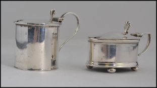 A near pair of silver hallmarked mustard pots with original liners,