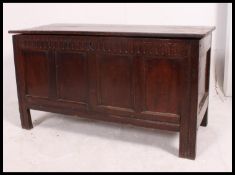 An 18th century country oak English coffer - blanket box chest raised on stile supports with plain