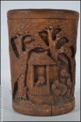 A 20th Chinese bamboo brush pot carved in details with family / pagoda village scenes complete with