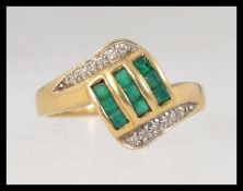 An Art Deco style 18ct gold and emerald diamond ring.