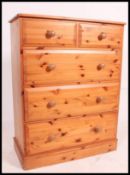 A Victorian style good quality pine chest of drawers being raised on plinth base with 2 short over