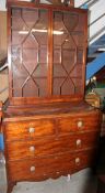 A 19th century Georgian mahogany bookcase on chest of drawers.