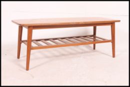 A vintage / retro 1970's Danish Influence solid teak coffee table raised on turned legs with