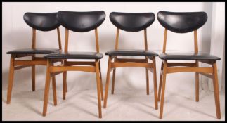 A set of four retro dining chair, having a teak affect,
