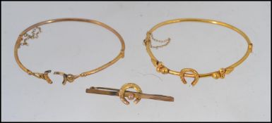 A pair of 9ct gold bracelets along with a matching 9ct gold brooch,