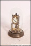A 19th century Gustav Becker anniversary clock within glass dome and brass circular base.