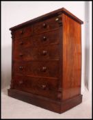 A large Victorian flame mahogany Scottish chest of drawers being raised on a plinth base with short