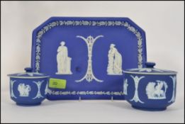 A group of three pieces of cobalt Wedgwood Jasperware having classical scenes to include a