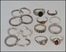 A collection of ladies silver - white metal ( tests as silver ) ladies earrings, all of hoop form.