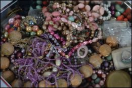 A collection of unsorted costume jewellery to include necklaces, bangles,