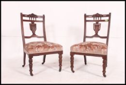 2 Edwardian mahogany nursing chairs being raised on turned legs with overstuffed seats and urn