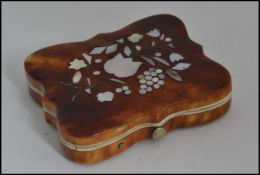 A Victorian tortoiseshell, mother of pearl and ivory photograph case.