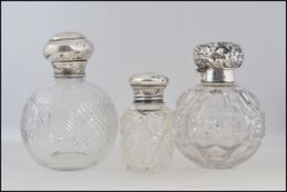 Three silver topped hallmarked cut glass perfume bottles,