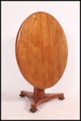 A Victorian mahogany tilt top dining table raised on a tripod base with turned column having