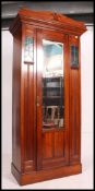 A Victorian Arts & Crafts mahogany single wardrobe having plinth base with central door and leaded