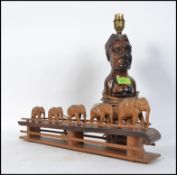 An African 20th century tribal hard wood figure of a mother carrying her baby on her back converted