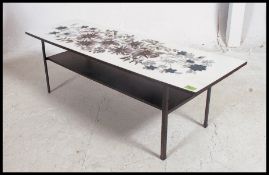 A vintage 1970's retro melamine long John coffee table raised on ebonised plinth base