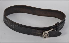 An original Australian 20th century Victoria police uniform belt being stamped for Hellweg 3953