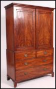 A 19th century mahogany linen press wardrobe. The top with twin doors housing a later rail.