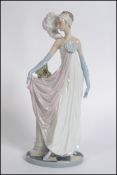 A Lladro figure of a 1920's lady 