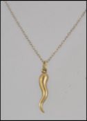 A 9ct gold pendant necklace with horn of plenty charm hallmarked Birmingham..