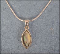 A ladies sterling silver and mother of pearl contemporary pendant necklace set on fine link chain