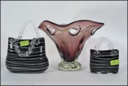 2 studio black and white glass handbag vases together with a large purple glass fruit bowl with