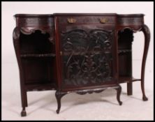 An Edwardian mahogany chiffonier sideboard with central glass cabinet flanked by open shelves with