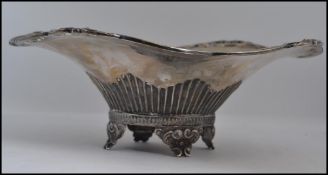 A silver hallmarked large fret pierced bowl on raised scrolled feet having reeded trumpet shaped