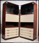 A pair of original Hulsta retro modular upright cabinet with white facia and mahogany bodies.
