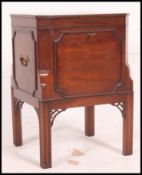 A 19th century mahogany wine cooler of square form raised on Chinese Chippendale legs having