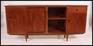 A retro 20th century teak sideboard of slim proportions, having two long sliding doors to one end,