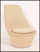 A vintage 1970's Heals swivel tub / egg shaped chair complete with the original fabric upholstery