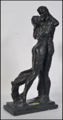 A Large hollow cast metal sculpture of entwined lovers raised on a twin plinth base - impressed