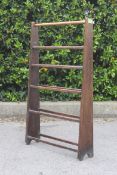 A retro mid century beech wood vintage towel rail of tapering form united by turned rails.