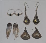 A collection of silver ( white metal ) tests as silver earrings to include art deco fan shape,