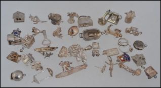 An extensive collection of white metal and silver white metal charms from a large charm bracelet.