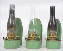 A collection of 3 1950's vintage wall mounted enamel oil lamps.