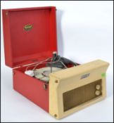A vintage 1950's retro two tone Dansette record player in red and white.