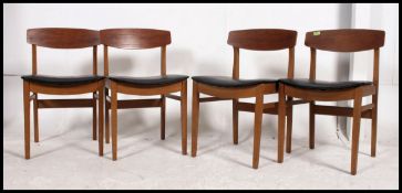 A set of 4 good 1970's teak dining chairs having original black vinyl pad seats and propeller