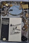 A collection of assorted locks and keys along with a boxed Vanguard stapler