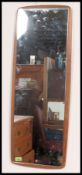 A retro 1970's atomic teak and frameless wall mirror.