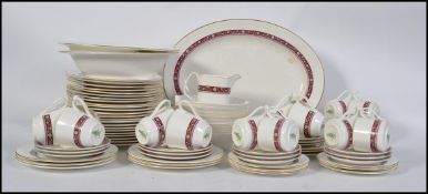 A Royal Doulton Minuet dinner / tea service / part service model H5026 comprising cups, saucers,