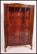 A good quality mahogany queen anne display cabinet raised on cabriole legs with shelved interior