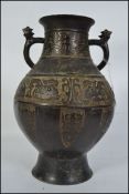 A large and heavy Chinese bronze twin handled vase / amphora.