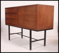 A 1970's Danish influence teak sideboard of rectangular form comprising drawers and fall front