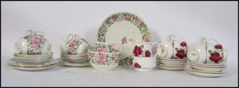 A vintage Crown Staffordshire china part tea service in a chintz pattern having 6 place setting.