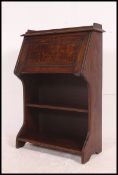 A 1940's oak student bureau desk, the top with all front slope,